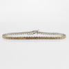 Rivière bracelet with natural, gradient cushion cut diamonds