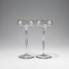 Two champagne glasses, c1899