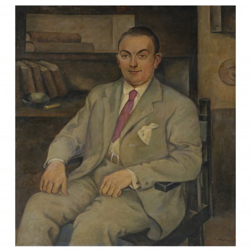 Portrait of a man seated on a wooden slat-chair, c. 1930