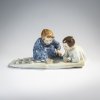 'Two children making sand molds', 1906 / before 1924