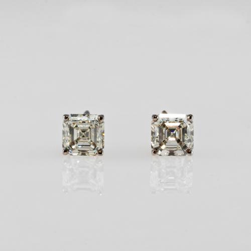 A pair of stud earrings set with Asscher-cut diamonds