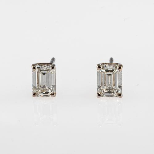 A pair of classic stud earrings set with emerald-cut diamonds