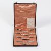 Twelve knife rests in a case, c. 1925
